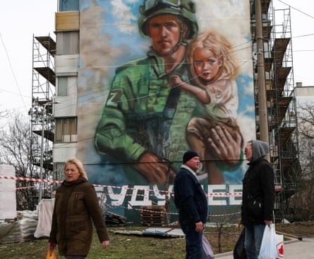 A mural depicting a serviceman with a Z letter patch, a tactical insignia of Russian troops in Ukraine, on the facade of a building in Chernomorskoye, on the west coast of the Crimean peninsula.