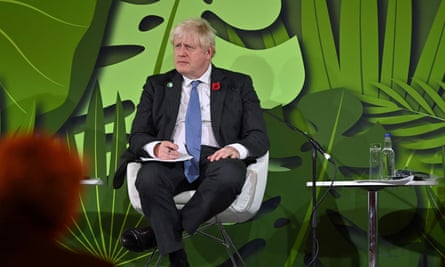 Boris Johnson listens to a speech during the UN Climate Change Conference (Cop26) in Glasgow