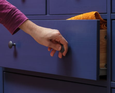 A person opens a dresser drawer