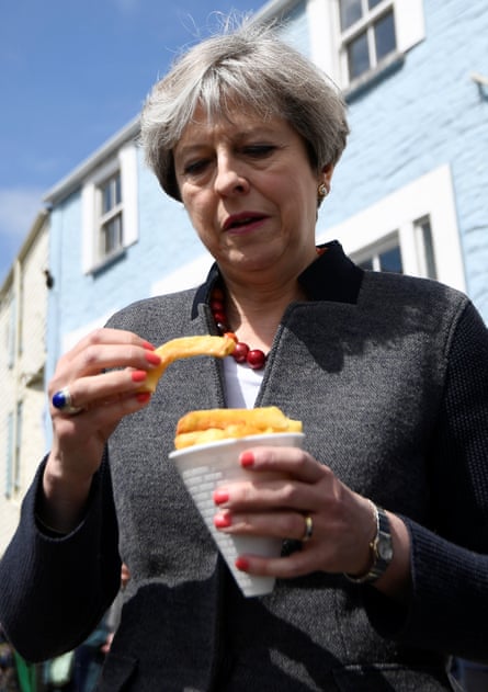 The prime minister of the United Kingdom looks suspiciously at a chip during her Cornwall visit.