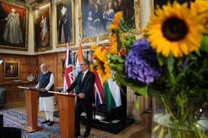 Starmer and Modi stand behind lecterns and address the media