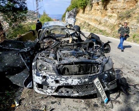 Destroyed wreckage of a car on a road