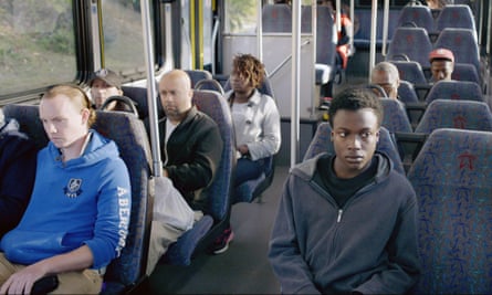Regina Williams sitting on a bus a couple of rows behind Andrew Bleechington, who plays her son, in Life and Nothing More.