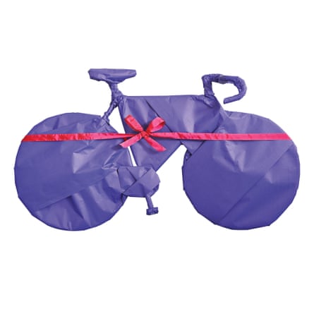Bike gift-wrapped in purple paper with pink ribbon