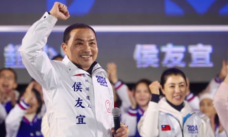 Hou You-yi raises a clenched fist as he stands among supporters at a campaign rally