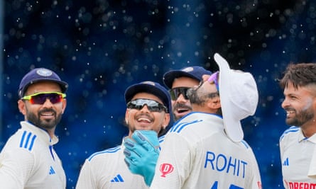 Rohit Sharma and his India players celebrate a wicket against West Indies in Trinidad.