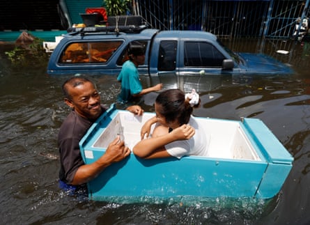 One resident uses a floating fridge as a boat.