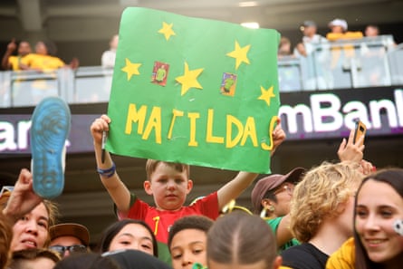 A boy with a Matildas sign.