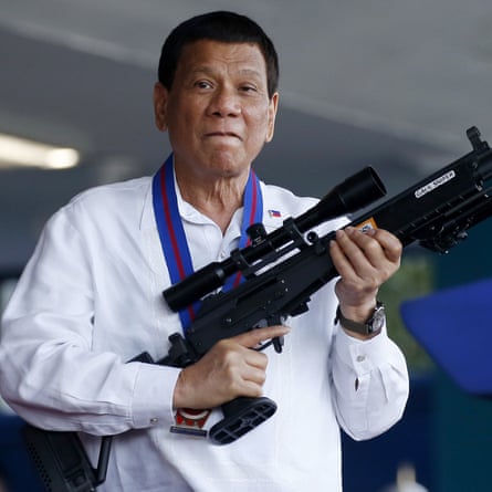 Rodrigo Duterte holding a gun