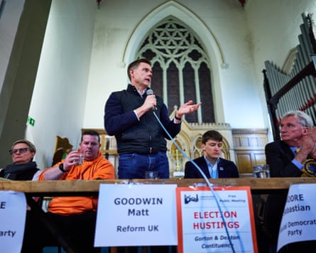 Goodwin speaks into a microphone while speaking in a church