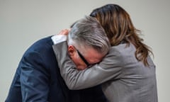 Actor Alec Baldwin, left, reacts as his wife Hilaria hugs him during a break in his trial for involuntary manslaughter for the 2021 fatal shooting of cinematographer Halyna Hutchins during filming of the Western movie "Rust," Friday, July 12, 2024, at Santa Fe County District Court in Santa Fe, N.M. (Eddie Moore/The Albuquerque Journal via AP, Pool)