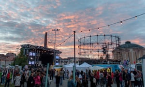 At dusk, crowds begin to gather at the stage for a performance at the Flow Festival in Finland.
