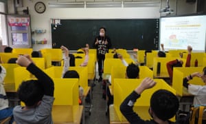 Pupils sitting behind partition boards to prevent infection of Covid-19.