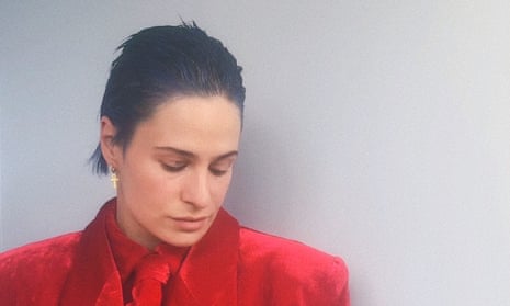 Contemplative moment in red: Rahim Redcar reflects his artistic depth.