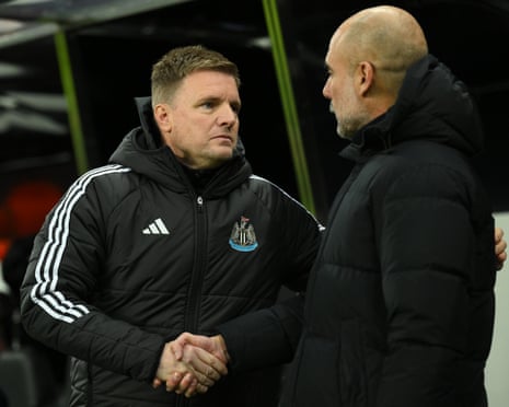 Eddie Howe manager of Newcastle United shakes hands with Pep Guardiola manager of Manchester City.