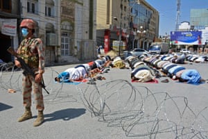 A security guard stands by as Muslim devotees offer first Friday prayers in Quetta, Pakistan