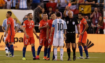 Referee Heber Lopes hands out a red card to Chile midfielder Marcelo Diaz