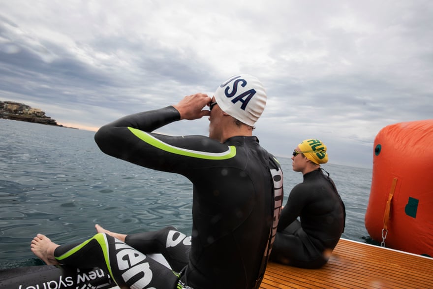 Australia’s Chelsea Gubecka and Charlie Clark of the US prepare for their leg of the relay.