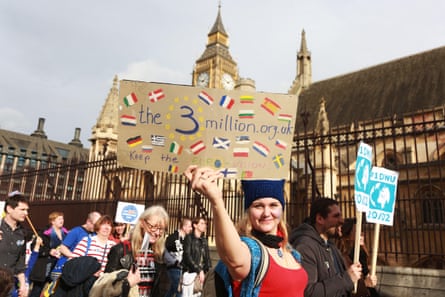 A woman holds up a the3million sign at a protest.