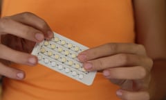Woman's hands holding birth control pills