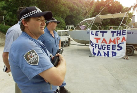 Australian police stand by as residents of Christmas Island protest against the closure of the island’s only port on 31 August 2001.