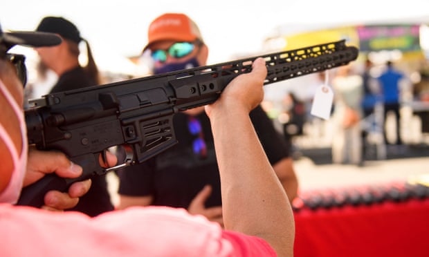 A customer holds an AR-15 style rifle at a gun show in Costa Mesa, California. 