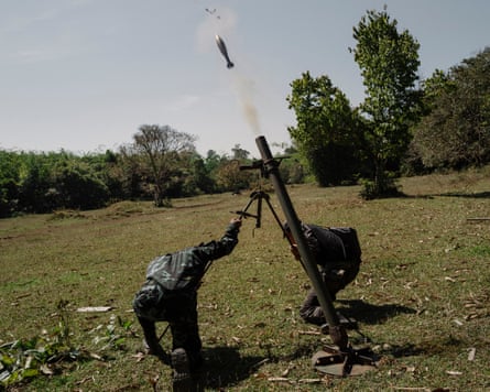 Resistance fighters fire mortar rounds toward Burmese army positions