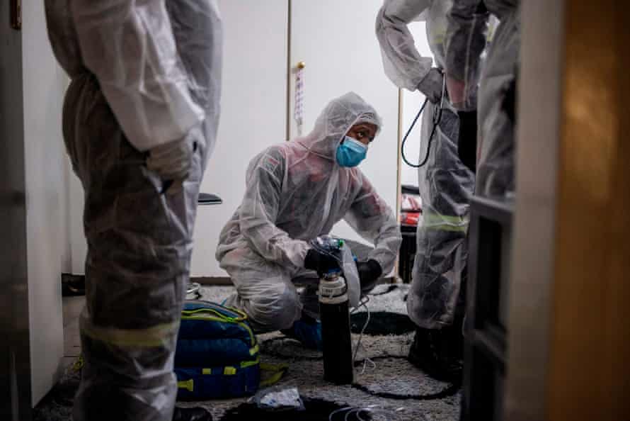 Paramedics assess a Covid-19 patient in Lenasia, Johannesburg.