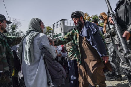 Heavily armed Taliban in army stopping a group of women protesting in Kabul