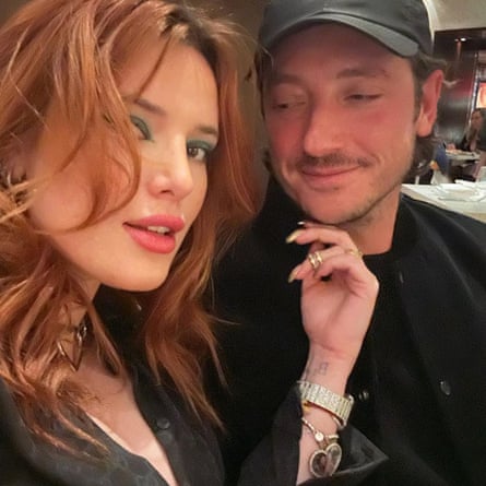 Close up of Bella Thorne tousled red hair, with hand touching Marks Emms’ chin beside her in an Instagram post from Thorne in May 2023.