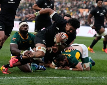 New Zealand’s captain Ardie Savea breaks away from South Africa’s captain Siya Kolisi to score a try in Johannesburg