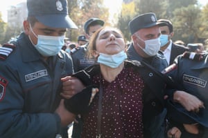 Yerevan, Armenia. Police officers detain a woman participating in a protest against the agreement signed to end the war in Nagorno-Karabakh