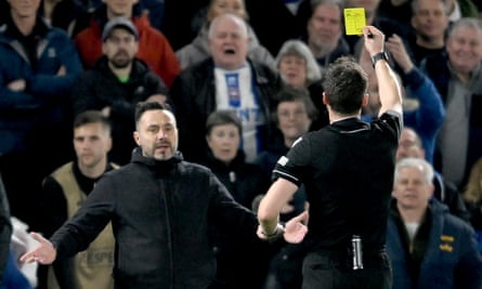 Frustrated Brighton manager Roberto De Zerbi is shown a yellow card