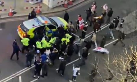 Clashes between police and protesters in Westminster as officers use a  vehicle to escort Starmer to safety on 7 February.