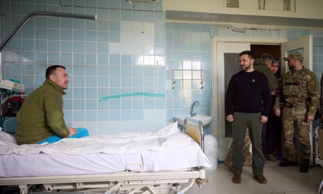 Ukraine's President Volodymyr Zelenskiy visits an injured Ukrainian service member at a military hospital, amid Russia's attack on Ukraine, in Donetsk region, Ukraine April 18, 2023.