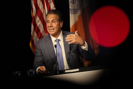 a man in a suit speaks into a microphone