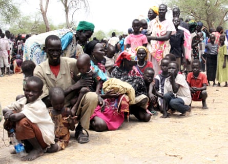 Residents displaced due to fighting between government and rebel forces in Malakal wait at a World Food Programme outpost.