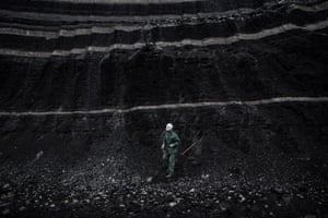 A PPC worker collects a coal sample.