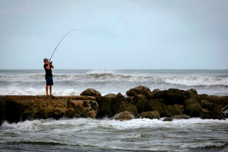 a man fishing by the water