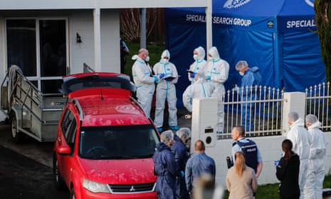 New Zealand police investigators work at a scene in Auckland on 11 August 2022 after two bodies were discovered in suitcases. A suspect has been handed over by South Korean authorities.