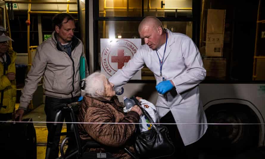 An eldery woman is pushed in a wheelchair