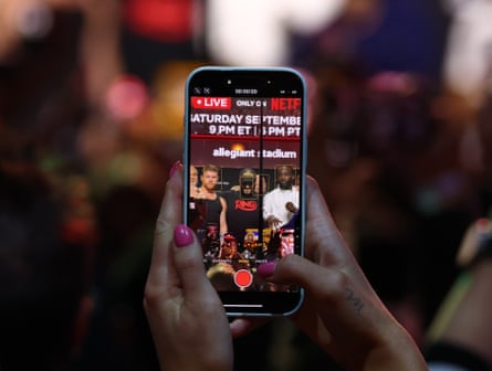 A fan takes a photo during the Canelo v Crawford press conference in Las Vegas.