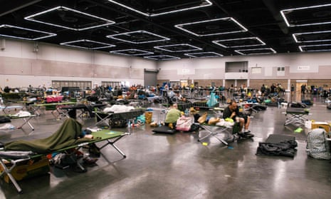 People rest at the Oregon Convention Center cooling station in Portland.