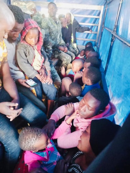 Refugees sit packed together at Maula prison, before being relocated to Dzaleka.