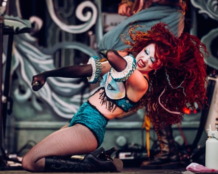 The musician Chappell Roan kneeling onstage