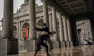 A boxing coach works out with his student on the arcade of the Royal Military museum at Cinquantenaire park in Brussels.