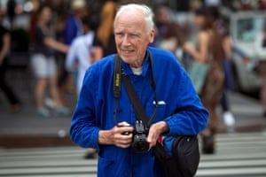 Bill Cunningham crosses the street after taking photos during New York Fashion Week in the Manhattan borough of New YorkNew York Times photographer Bill Cunningham crosses the street after taking photos during New York Fashion Week in the Manhattan borough of New York September 6, 2014. REUTERS/Carlo Allegri/File Photo