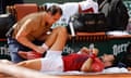 Novak Djokovic receives medical assistance for his right knee during his fourth round match at the French Open.