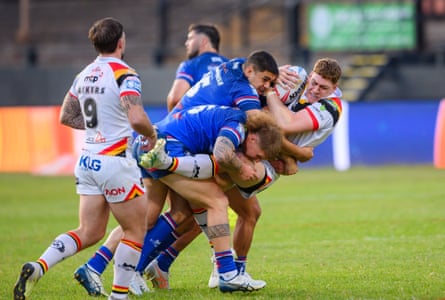 Bradford's Daniel Russell receives a double tackle by Wakefield's Caleb Hamlin-Uele & Caius Faatili.