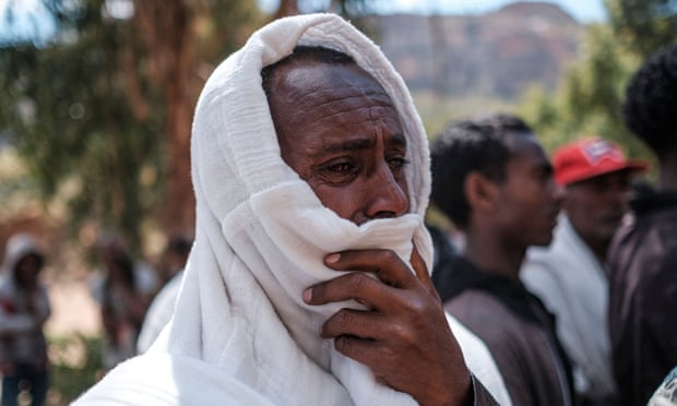 A man mourns the victims of a massacre allegedly perpetrated by Eritrean soldiers in the village of Dengolat